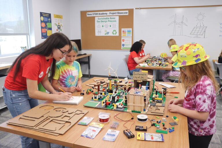 Instructor helping kids at a classroom table