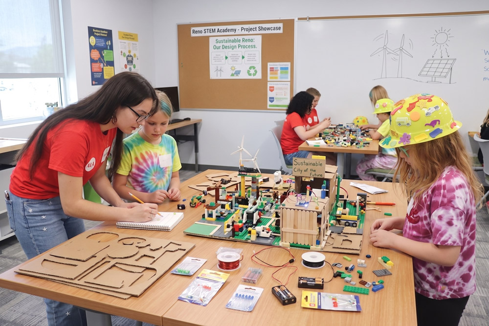 Instructor helping kids at a classroom table