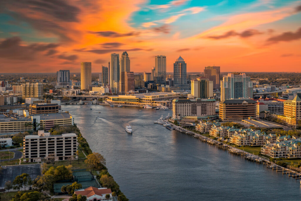 Aerial view of downtown Tampa Florida skyline along the water at sunset.