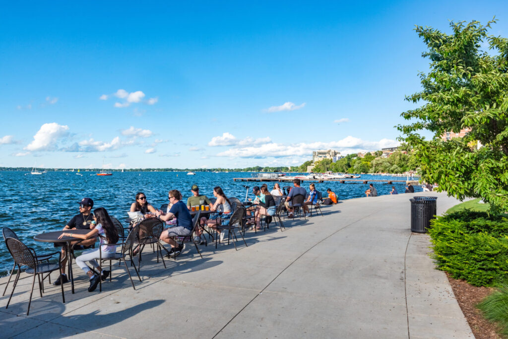 People on Lake Mendota near the Madison Wisconsin skyline.