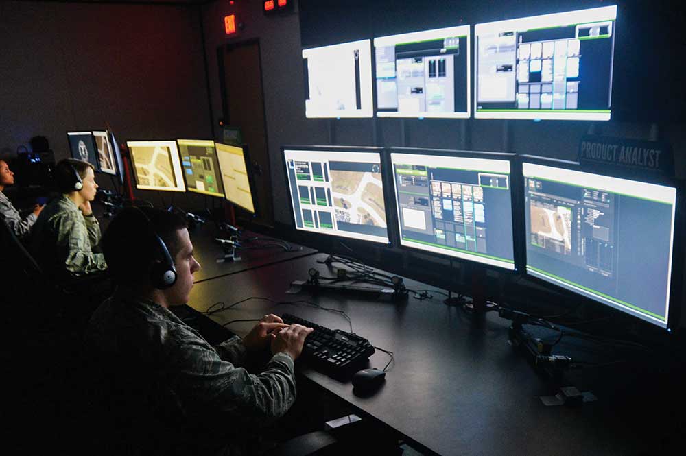 U.S. Air Force 2nd Lt. Michael Emard, 711th Human Performance Wing behavioral scientist, creates slides from video snapshots that would be sent to soldiers in the field, during a demonstration of the new Enhanced Reporting, Narrative Event Streaming Tool developed by the Air Force Research Lab, at Wright-Patterson Air Force Base, Ohio, Oct. 15, 2014. The program streamlines some routine tasks performed by intelligence analysts in an effort to increase their overall effectiveness allow for faster distribution of intel to those that need it. (U.S. Air Force photo by Wesley Farnsworth)