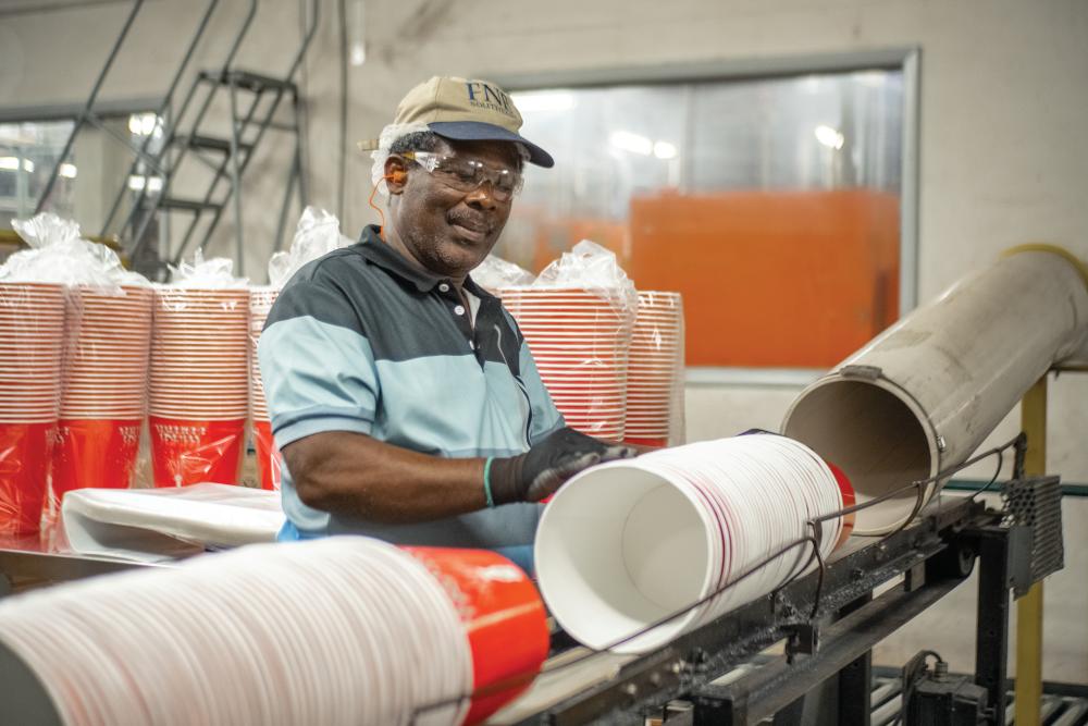 Graphic Packaging employee working on the cup line