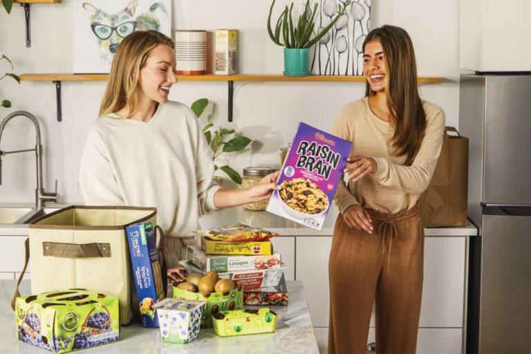 two women unload grocery items, many with packaging created by Graphic Packaging
