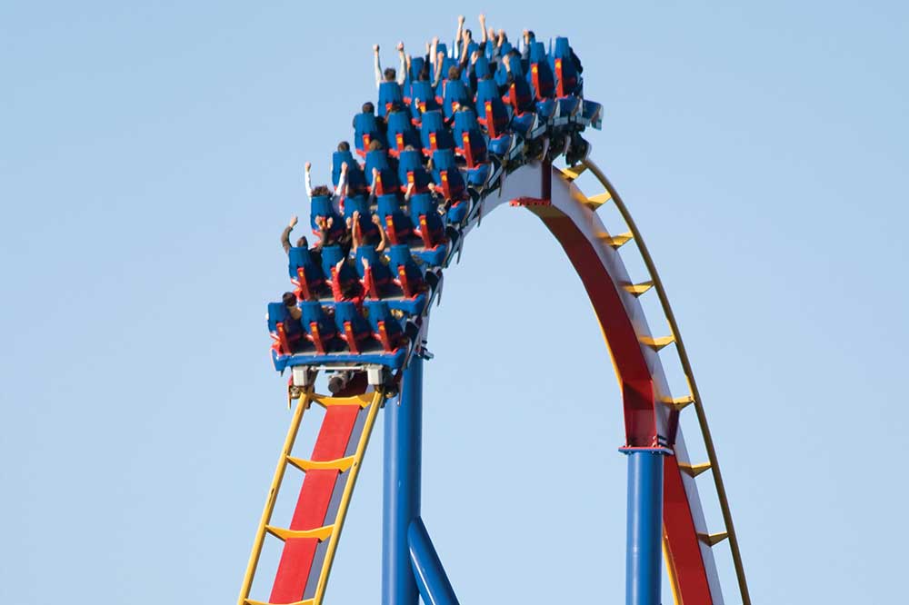 Colorful roller coaster lit by low sunset to accentuate saturation.