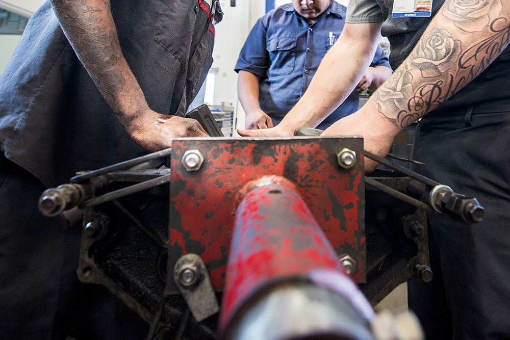 Deaf students use sign language to communicate while working on cars at the Tennessee College of Applied Technology's Nissan Training Center in Smyrna, Tennessee.