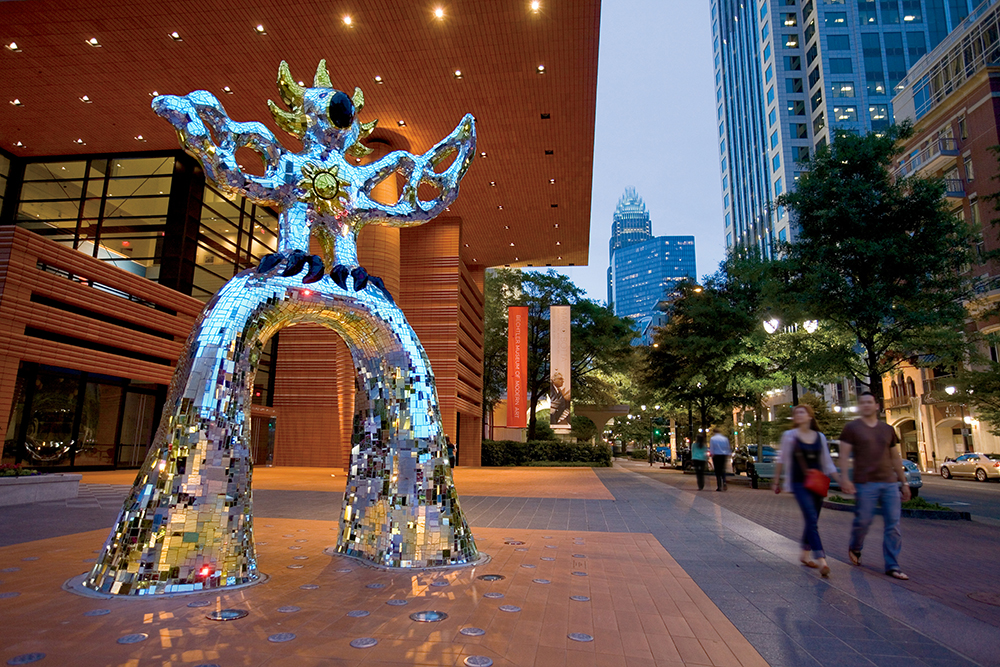Visitors walk past a sculpture called The Firebird which stands in front of the main entrance to the Bechtler Museum of Modern Art in downtown Charlotte, North Carolina. The Firebird was created by artist Niki de Saint Phalle in 1991.