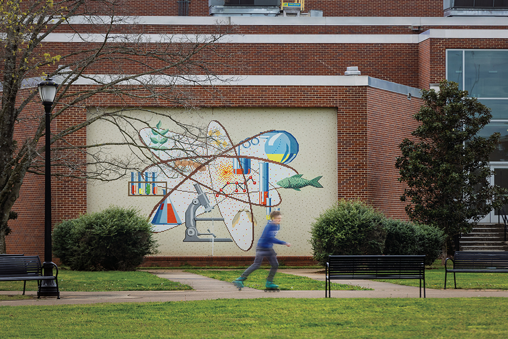 A student skates past a mural on the campus of Middle Tennessee State University (MTSU) in Murfreesboro, Tennessee.