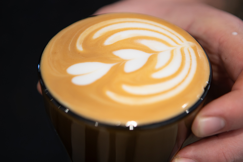 Brennan Cox makes coffee behind the counter at Brass Horn Coffee in Murfreesboro.