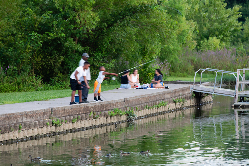 Children fish from the sidewalk at Memorial Park in Hendersonville, Tennessee.