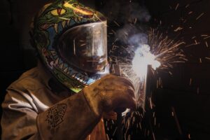 Isaac Salazar, a senior at Roy Miller High School, welds a plate of steel in the welding program at the Craft Training Center of the Coastal Bend in Corpus Christi.