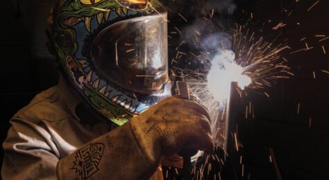 Isaac Salazar, a senior at Roy Miller High School, welds a plate of steel in the welding program at the Craft Training Center of the Coastal Bend in Corpus Christi.