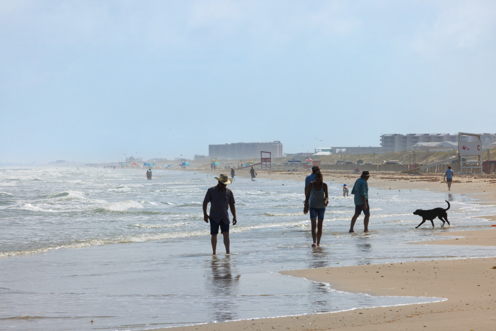 People walk along the beach in Port Aransas. 