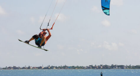 Jeff Chilcoat jumps his kite board over a row of vegetation at Oso Bay in Corpus Christi.