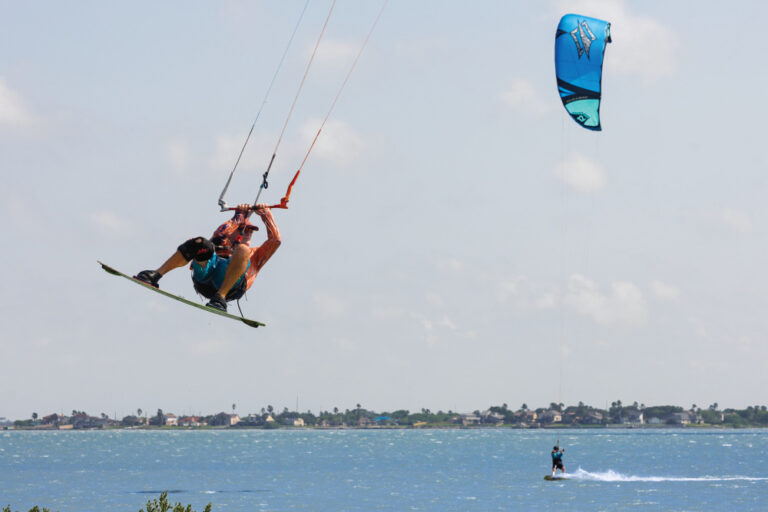 Jeff Chilcoat jumps his kite board over a row of vegetation at Oso Bay in Corpus Christi.