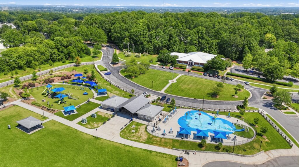 The 64-acre Harrisburg Park property includes five multipurpose fields, a paved walking track measuring approximately 0.54 miles per lap, trails, sidewalks, a mountain-bike trail, a bicycle pump track, and seasonal concessions.