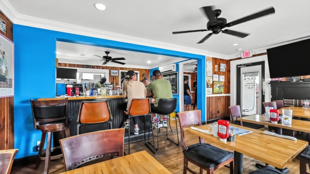 A man and woman sit at the bar of The Neighborhood Cafe