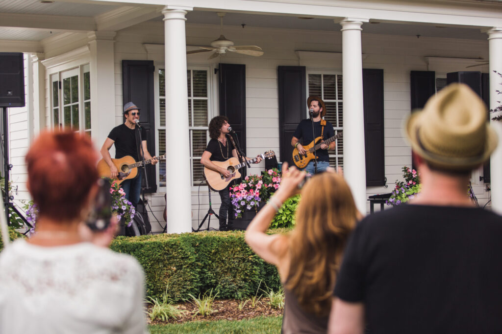 Guests gather in front of a porch performance in the Westhaven community of Franklin, Tennessee.