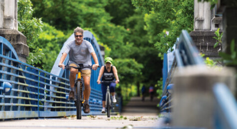 Cyclists cross the Mike Howard Memorial Bridge along the South Chickamauga Creek Greenway in Chattanooga, Tennessee.