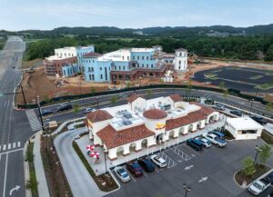 Aerial view of an In-N-Out Burger restaurant in Franklin, Tennessee, with a large office building under construction across the street