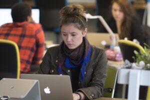 Employees work in the open office space environment at CO.LAB