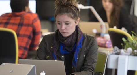 Employees work in the open office space environment at CO.LAB