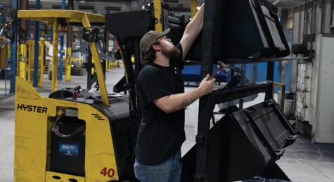 Employees move buckets around the manufacturing floor at Virnig Manufacturing in Pikeville, Tennessee.
