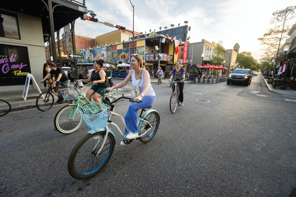 Cyclists take off from Loda Bier Garten on Dauphin Street for a weekly ride through downtown Mobile, Alabama. 