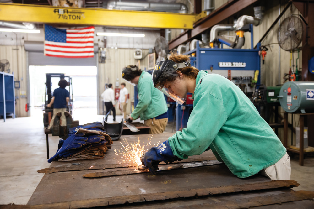 Ethan Anderson uses a grinder on a piece of steel in his welding at Alma Bryant High School in Irvington.