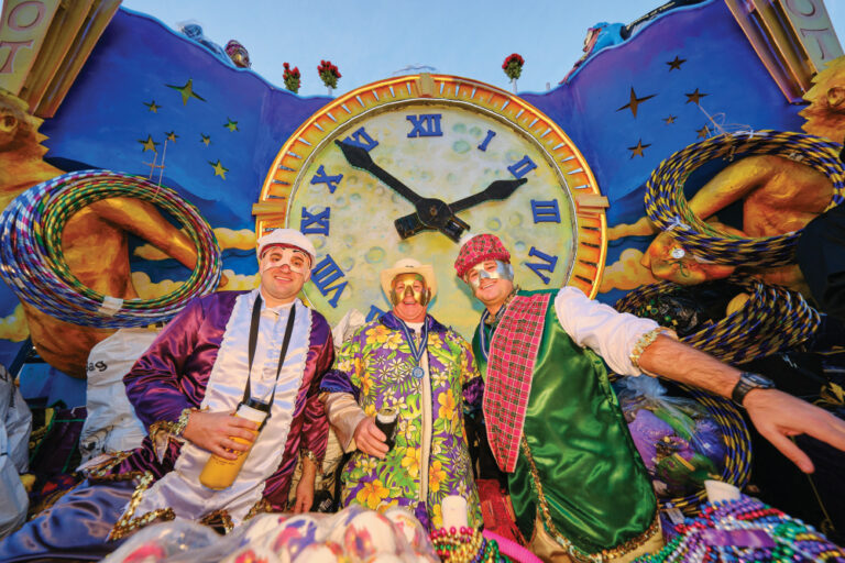 Members of the Mystics of Time (MOT) mystic society on board a float in Mardi Gras in Mobile, AL