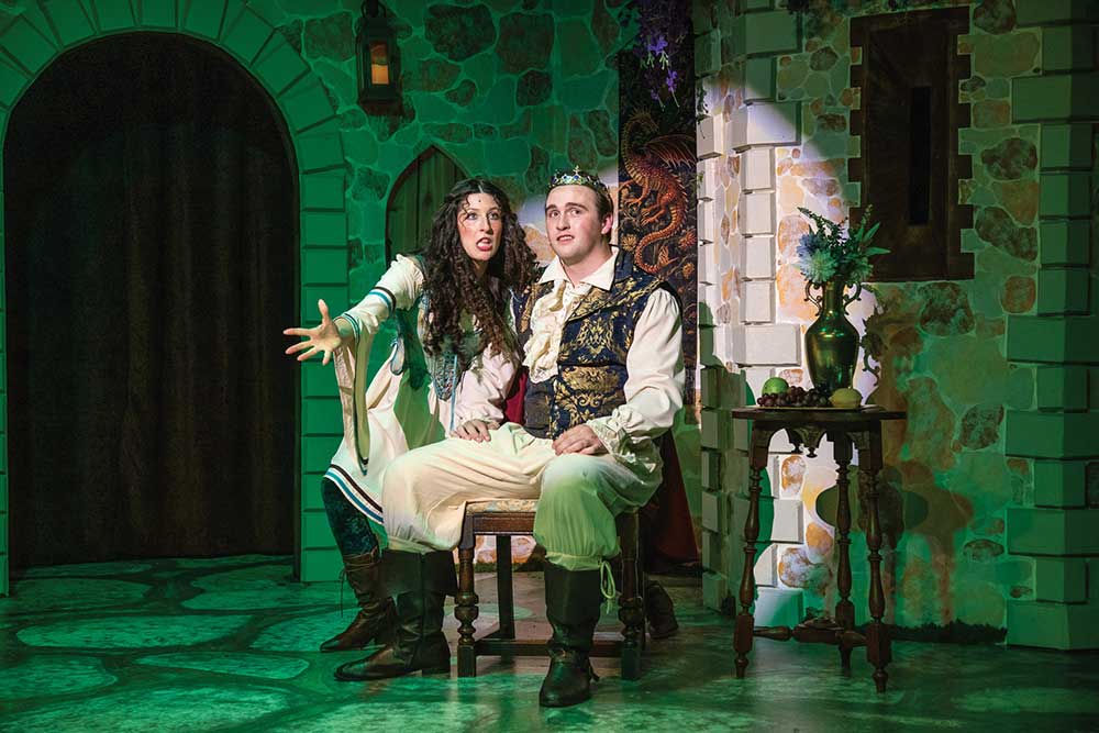 Two actors in Renaissance-style costumes on a castle set during a Pull-Tight Players production in downtown Franklin, TN