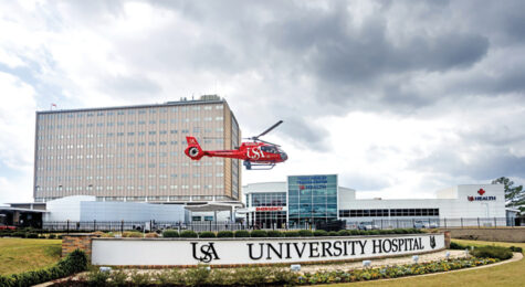 USA Health University Hospital exterior with USA Health SouthFlight helicopter